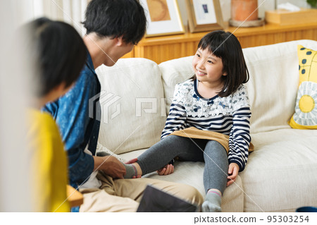 Family gathering together in the living room of the house Family gathering together in the living room of the house 95303254