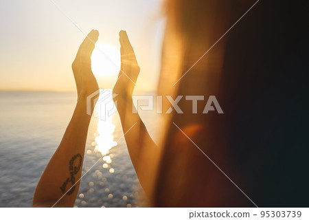 silhouette of female hands during sunset. Concept of life. silhouette of female hands during sunset. Concept of life. 95303739
