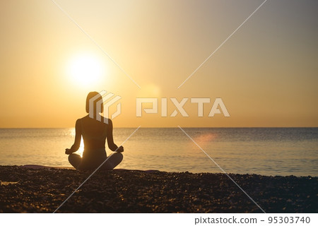 Silhouette young woman practicing yoga on the beach at sunset, Karon Beach ,Phuket ,Thailand. For Silhouette young woman practicing yoga on the beach at sunset, Karon Beach ,Phuket ,Thailand. For 95303740