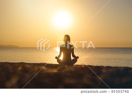Silhouette young woman practicing yoga on the beach at sunset, Karon Beach ,Phuket ,Thailand. For Silhouette young woman practicing yoga on the beach at sunset, Karon Beach ,Phuket ,Thailand. For 95303748