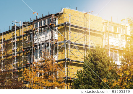 Multistory wall insulation during autumn season 95305379
