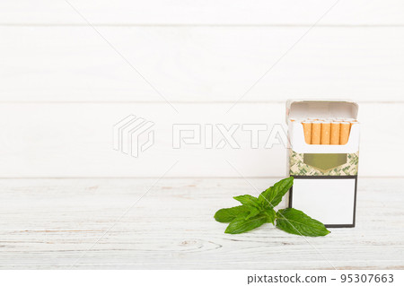 Pack of menthol cigarettes and fresh mint on colored table, Menthol cigarettes top view flat lay 95307663
