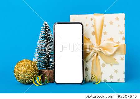 Digital phone mock up with rustic Christmas decorations for app presentation with empty space for you design. Christmas online shopping concept. Tablet with copy space on colored background Digital phone mock up with rustic Christmas decorations for app presentation with empty space for you design. Christmas online shopping concept. Tablet with copy space on colored background 95307679
