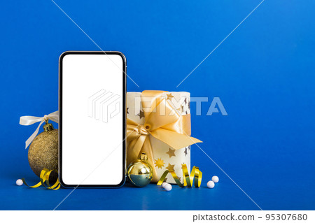 Digital phone mock up with rustic Christmas decorations for app presentation with empty space for you design. Christmas online shopping concept. Tablet with copy space on colored background Digital phone mock up with rustic Christmas decorations for app presentation with empty space for you design. Christmas online shopping concept. Tablet with copy space on colored background 95307680