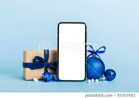Digital phone mock up with rustic Christmas decorations for app presentation with empty space for you design. Christmas online shopping concept. Tablet with copy space on colored background Digital phone mock up with rustic Christmas decorations for app presentation with empty space for you design. Christmas online shopping concept. Tablet with copy space on colored background 95307681