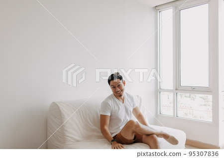 Single man playing with his sugarglider pet alone in his apartment. 95307836