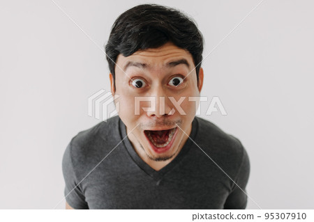 Funny surprised shocked asian man face see promotion isolated on background. 95307910