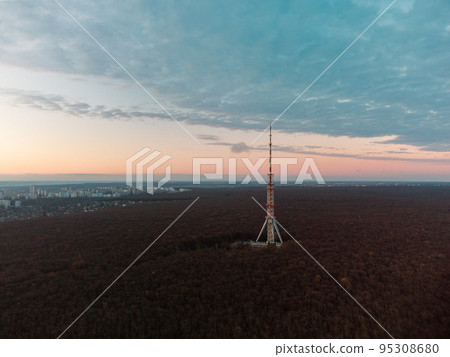Aerial evening view with telecom tower in forest Aerial evening view with telecom tower in forest 95308680