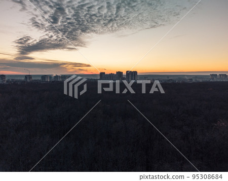 Aerial dark city and forest, epic sunset evening 95308684