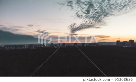 Aerial dark city and forest, epic sunset evening Aerial dark city and forest, epic sunset evening 95308686