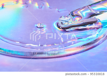 Pipette with sample of cosmetic product in petri dish on holographic background, iridescent highlights, selective focus 95310818