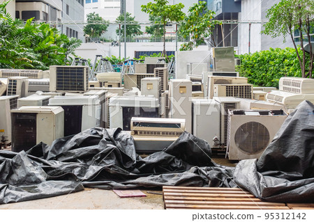 A lot of Air conditioners stacked up in a pile to disposal at recycling garbage dump. Stack of old and dirty air conditioners defective and discarded for recycling process industry. Old appliances. A lot of Air conditioners stacked up in a pile to disposal at recycling garbage dump. Stack of old and dirty air conditioners defective and discarded for recycling process industry. Old appliances. 95312142