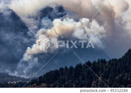 BC Forest Fire and Smoke over the mountain near Hope during a hot sunny summer day. BC Forest Fire and Smoke over the mountain near Hope during a hot sunny summer day. 95312286