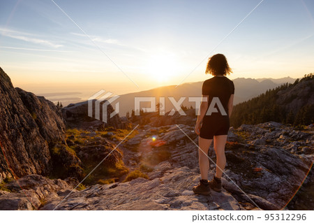 Adventurous Woman Hiker on top of Canadian Mountain Landscape. Adventurous Woman Hiker on top of Canadian Mountain Landscape. 95312296
