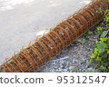 roll of rusty construction rebar on ground 95312547