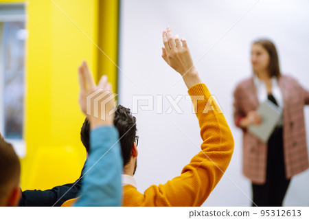 Business people raising hand up to ask question with speaker Business people raising hand up to ask question with speaker 95312613