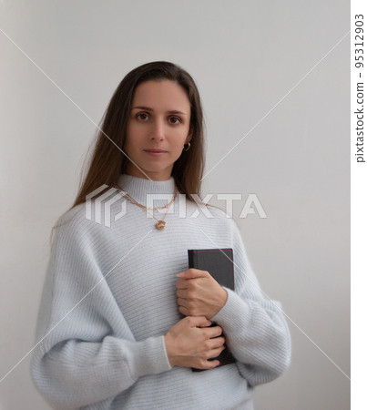 Low angle of young pretty bussines woman standing with arms crossed isolated on white background Low angle of young pretty bussines woman standing with arms crossed isolated on white background 95312903