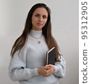 Low angle of young pretty bussines woman standing with arms crossed isolated on white background 95312905