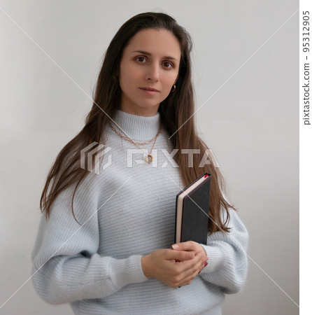 Low angle of young pretty bussines woman standing with arms crossed isolated on white background Low angle of young pretty bussines woman standing with arms crossed isolated on white background 95312905