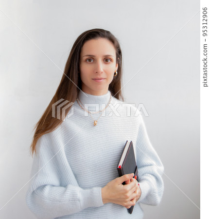 Low angle of young pretty bussines woman standing with arms crossed isolated on white background Low angle of young pretty bussines woman standing with arms crossed isolated on white background 95312906