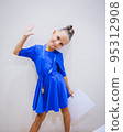 Beautiful happy smiling gymnast and dance girl in sportswear dress showing her medals. 95312908