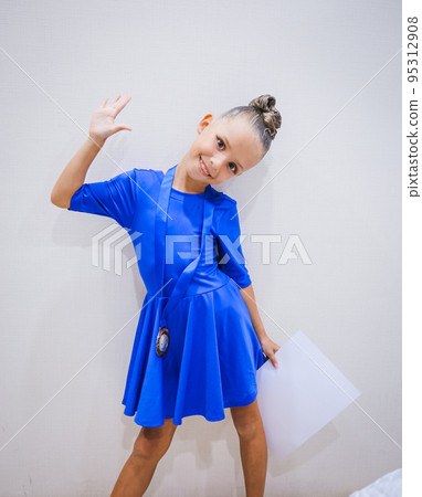 Beautiful happy smiling gymnast and dance girl in sportswear dress showing her medals. Beautiful happy smiling gymnast and dance girl in sportswear dress showing her medals. 95312908