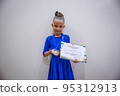 Beautiful happy smiling gymnast and dance girl in sportswear dress showing her medals. 95312913