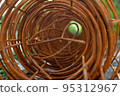 selective focus of roll of rusty construction rebar on ground 95312967