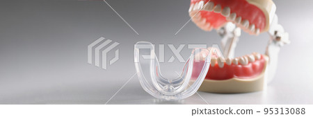 Plastic model of an open human jaw on a gray background 95313088