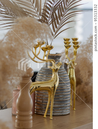 Golden deer decorative element with a gray stripped vase vertical. Golden deer decorative element with a gray stripped vase vertical. 95313332