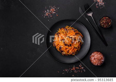 Korean salad with eggplant, carrots, garlic, spices and herbs on a dark concrete background Korean salad with eggplant, carrots, garlic, spices and herbs on a dark concrete background 95313685