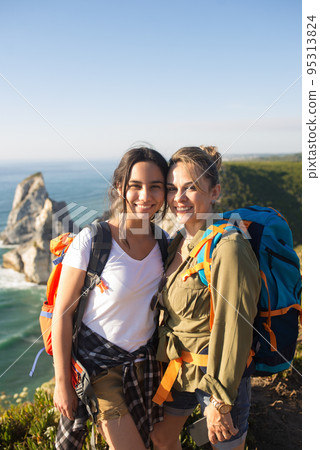 Portrait of smiling mother and daughter hiking 95313824