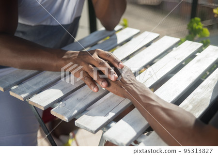 Close-up of two African American gay mens hands Close-up of two African American gay mens hands 95313827