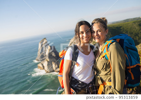Portrait of happy mother and daughter in mountains Portrait of happy mother and daughter in mountains 95313859