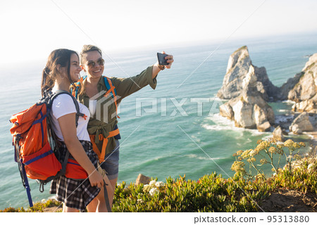 Happy mid adult woman taking selfie with daughter 95313880