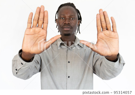 Portrait of confident young businessman making stop gesture 95314057