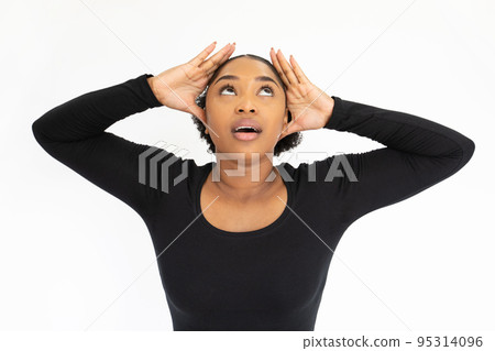 Portrait of depressed young woman holding head in hands 95314096