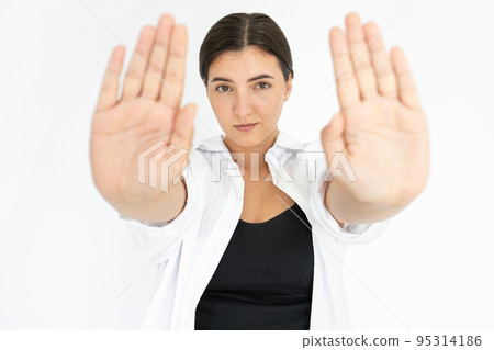 Portrait of serious young woman making refusal gesture 95314186