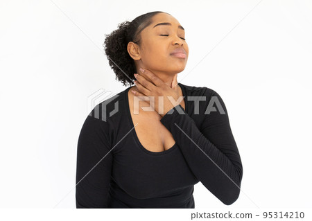 Portrait of unhappy young woman touching neck 95314210