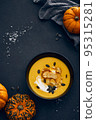 Pumpkin cream soup with croutons on dark background 95315281
