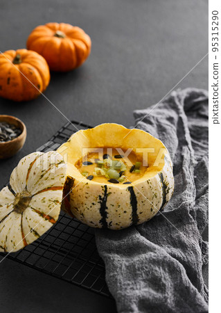 Pumpkin cream soup served in a squash with seeds Pumpkin cream soup served in a squash with seeds 95315290