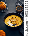 Pumpkin cream soup with croutons on dark background 95315291