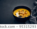 Pumpkin cream soup with croutons on dark background 95315293