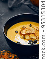 Pumpkin cream soup with croutons on dark background 95315304