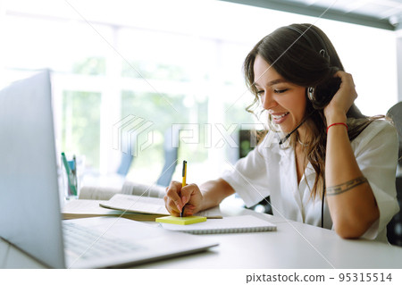 Young operator woman agent with headsets working in a call centre. Call center service. Young operator woman agent with headsets working in a call centre. Call center service. 95315514