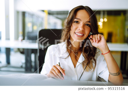 Young operator woman agent with headsets working in a call centre. Call center service. Young operator woman agent with headsets working in a call centre. Call center service. 95315516