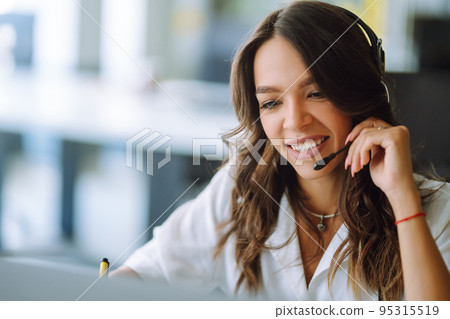 Young operator woman agent with headsets working in a call centre. Call center service. 95315519