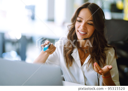 Young operator woman agent with headsets working in a call centre. Call center service. 95315520