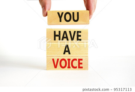 You have a voice symbol. Concept words You have a voice on wooden blocks. Beautiful white table white background. Businessman hand. Business, psychological you have a voice concept. Copy space. 95317113