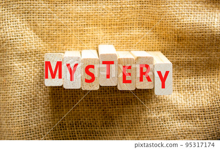Mystery symbol. The concept word Mystery on wooden blocks. Beautiful canvas background, copy space. Business and mystery mysterious concept. Mystery symbol. The concept word Mystery on wooden blocks. Beautiful canvas background, copy space. Business and mystery mysterious concept. 95317174